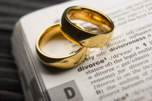 Divorce and separation concept. Two golden wedding rings. Dictionary definition.