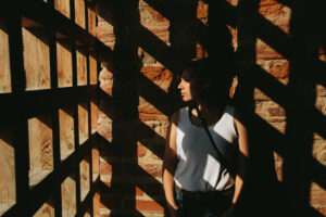 Woman sitting in shadow