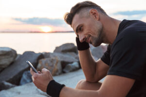 Man looking at his phone outdoors