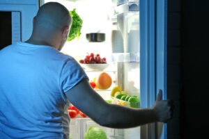 Man taking food from refrigerator