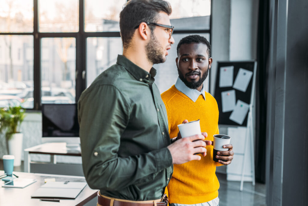 Two businessmen talking at work