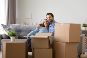 Couple sitting in living room with moving boxes