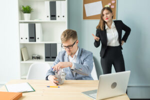 Annoyed woman trying to get male colleague's attention