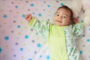 Smiling baby girl on bed