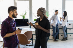 Businessman and woman speaking at work