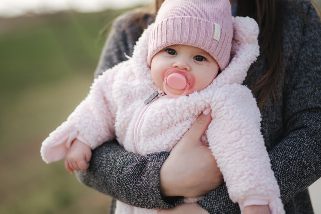 Parent holding baby girl