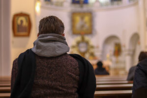 Back view of man sitting in church