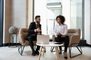 Multiracial business partners cooperate work on laptop together