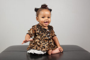 Black baby girl wearing cheetah print dress