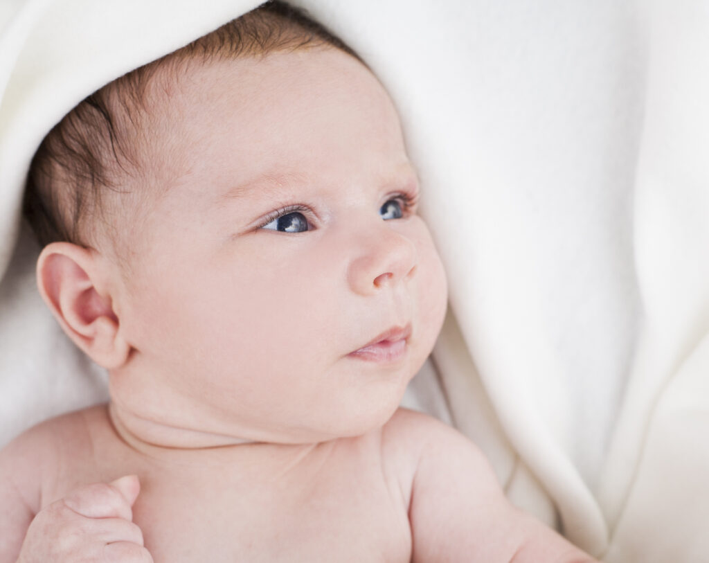 baby wrapped in white blanket