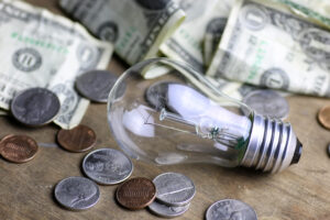 coins and crumpled money tungsten lamp filament