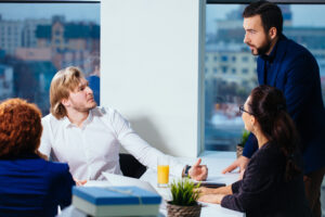 Businessman looking taken aback at business meeting