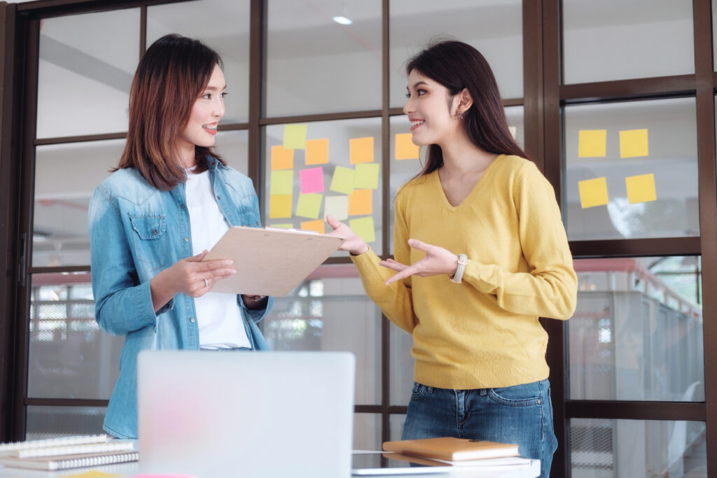 Two women brainstorming at work