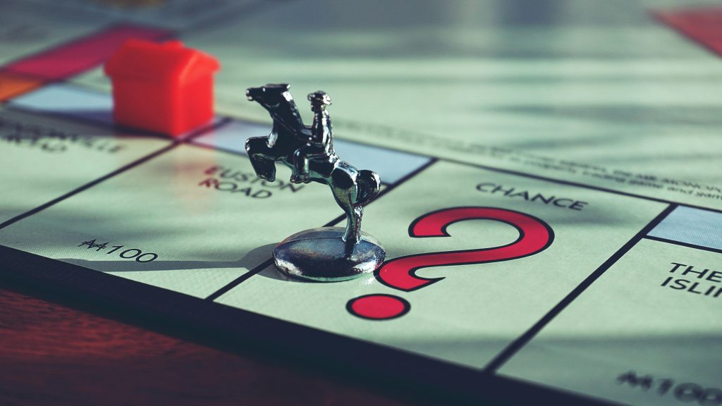 Grandchildren playing Monopoly with Baby Boomer Grandparents